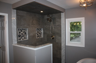 Custom tiles shower with his and her niches.